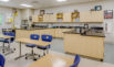 Thumbnail of A photograph of a science lab and classroom in the Polk County Early College showing a mix of laboratory spaces in the rear of the classroom as well as desks in the front. Click to view larger image.