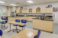 A photograph of a science lab and classroom in the Polk County Early College showing a mix of laboratory spaces in the rear of the classroom as well as desks in the front.