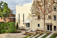 View of side entrance from amphitheater with existing building to the right.