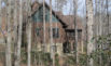 Thumbnail of A side view of this private residence illustrating a screen porch facing Lake Lanier. Click to view larger image.