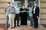 John Walters, Colin Walker, Tim Brannon, Tara Brannon, Brad Greene and Marianne Carruth cutting a ribbon to open the new Tryon Fine Arts Center.